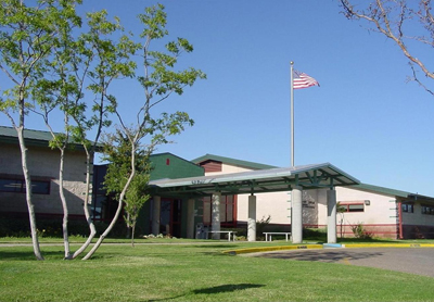 A Hospital building with an American flag flying in front.