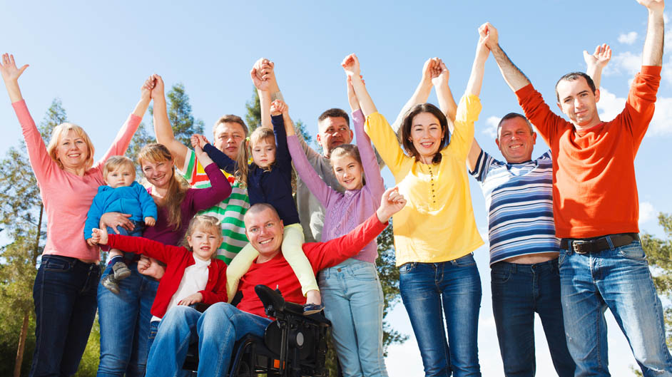 Disabled Man with Group of people raising hands outdoors